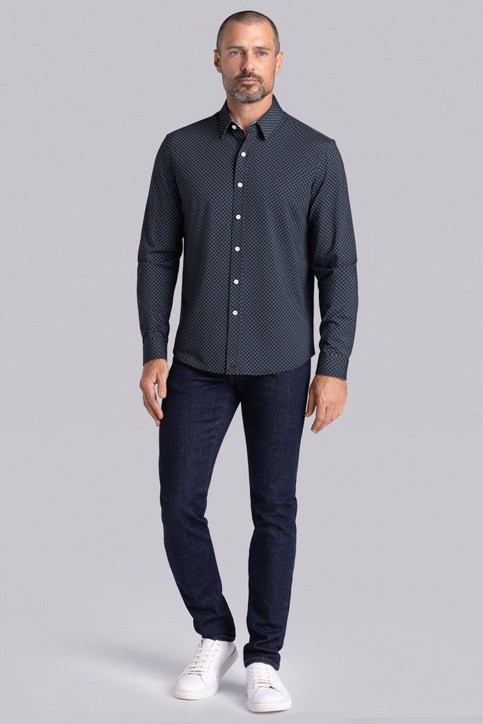 Model wearing Empower Black Green long sleeve dress shirt, styled black pants.