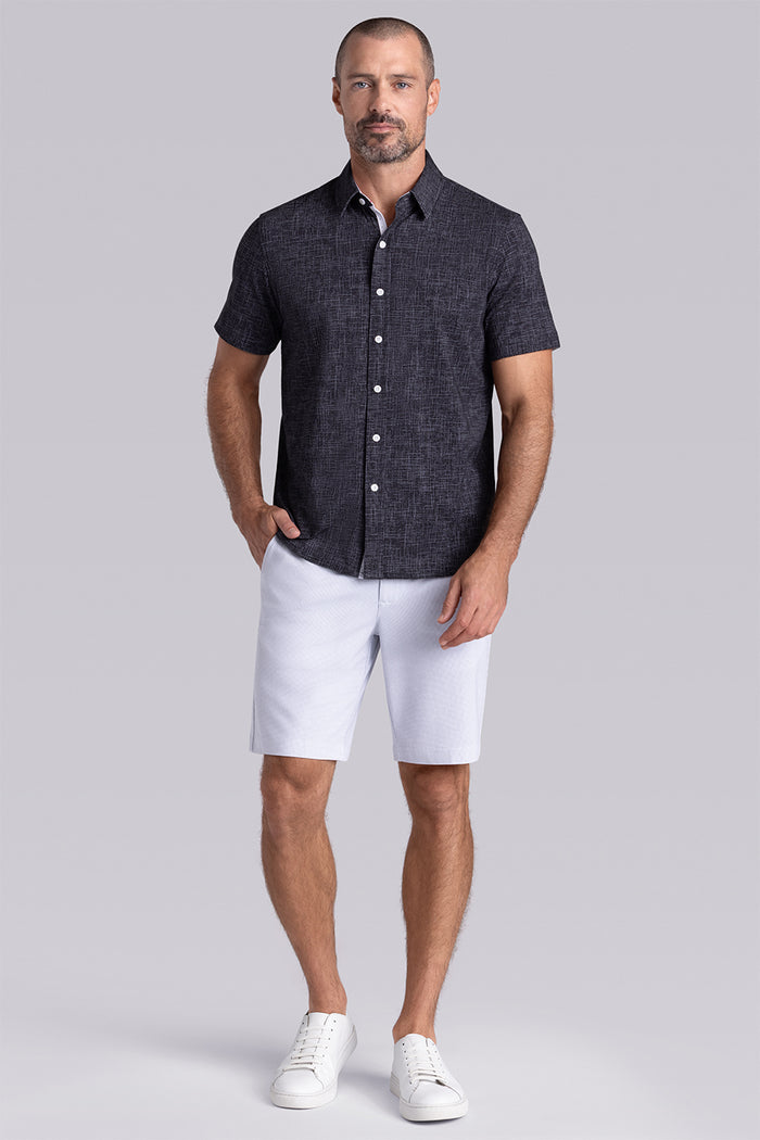 Model wearing Encore Black short sleeve classic collar shirt, style with white shorts