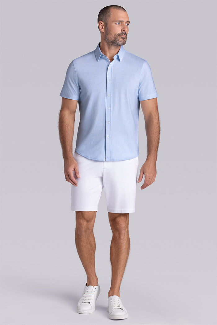 Model wearing Encore Light Blue short sleeve classic collar shirt, style with white shorts
