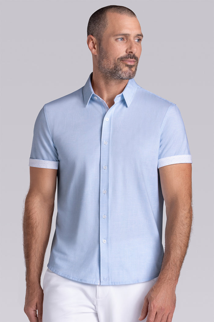 Model wearing Encore Light Blue short sleeve classic collar shirt, style with white shorts