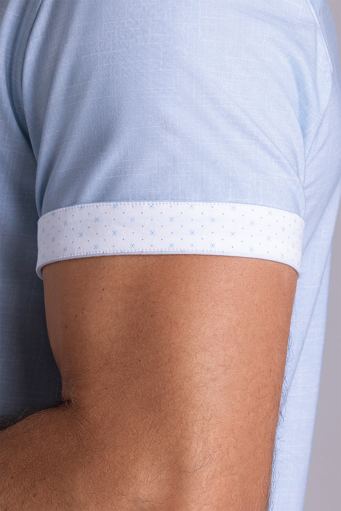 Model wearing Encore Light Blue short sleeve classic collar shirt, style with white shorts
