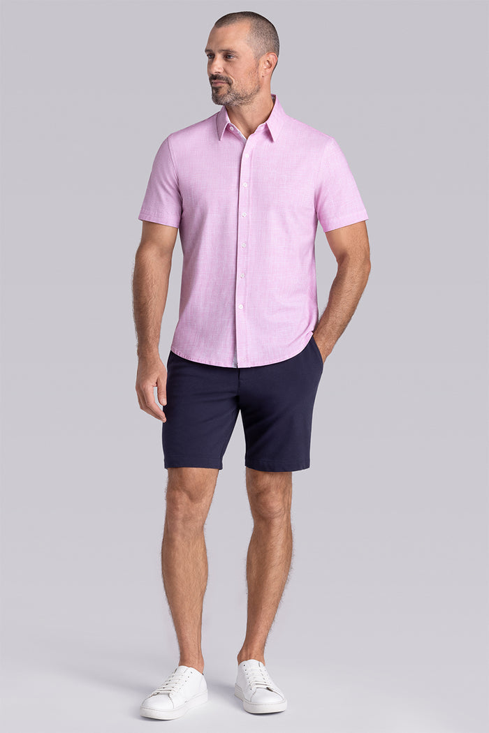 Model wearing Encore Light Pink short sleeve classic collar shirt, style with black shorts