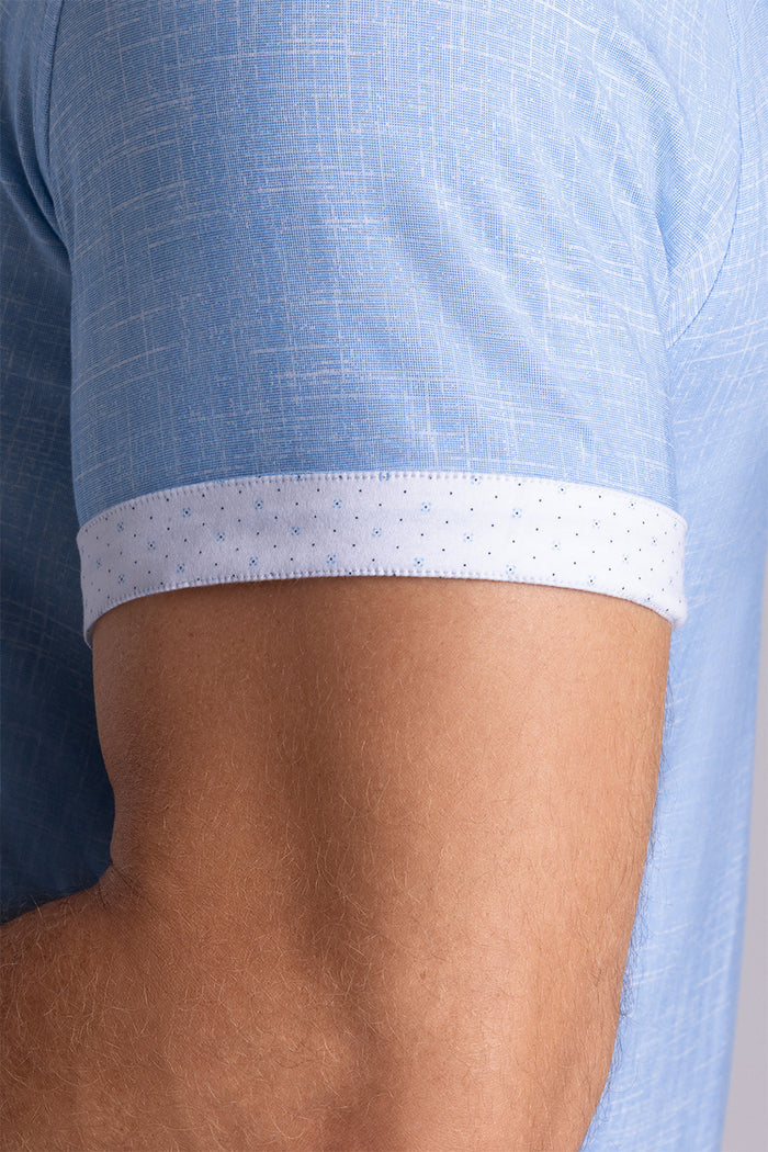 Model wearing Encore Ocean Blue short sleeve classic collar shirt, style with white pants