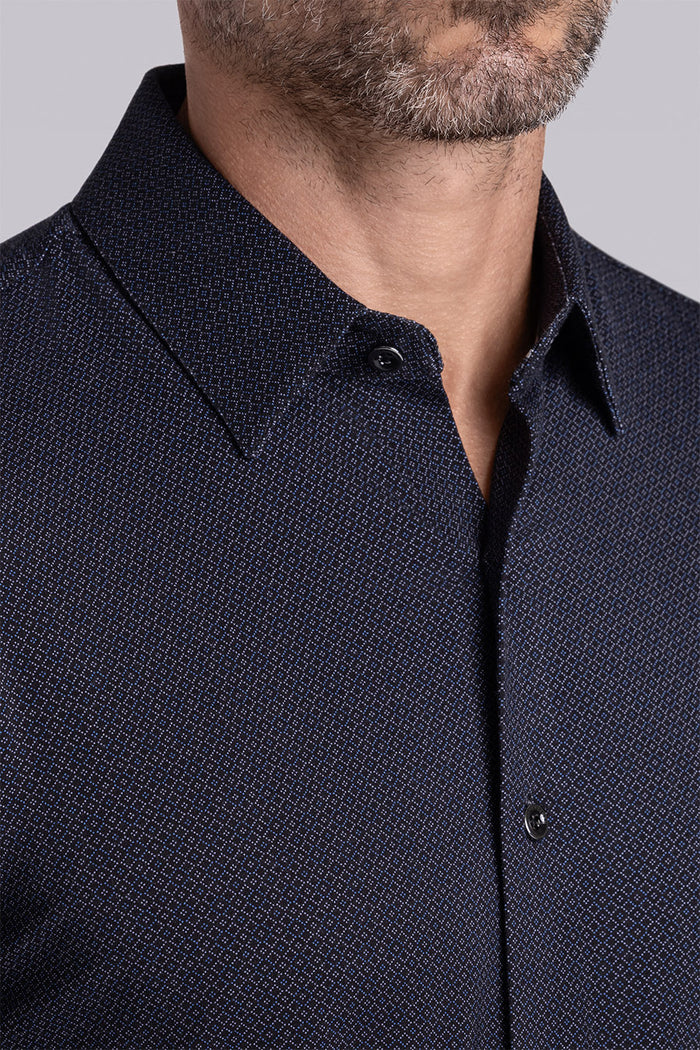 Model wearing the Excelsior Black Ink long sleeve dress shirt, styled with fitted black dress slacks.