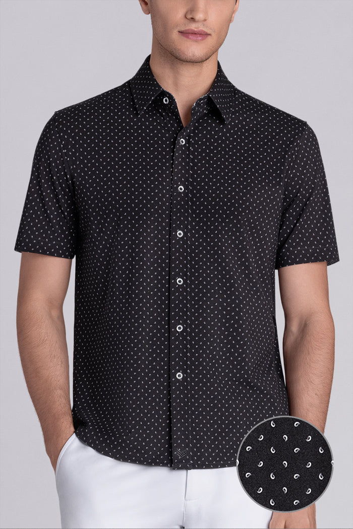 Model wearing Exhilarate Black short sleeve shirt, styled with white shorts
