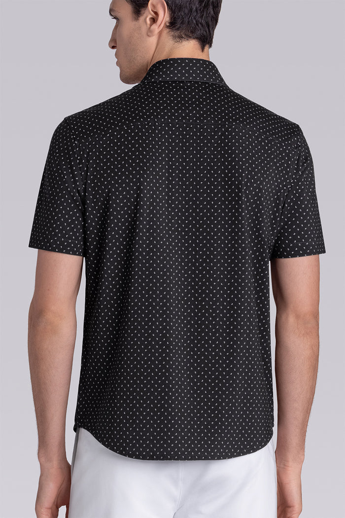 Model wearing Exhilarate Black short sleeve shirt, styled with white shorts