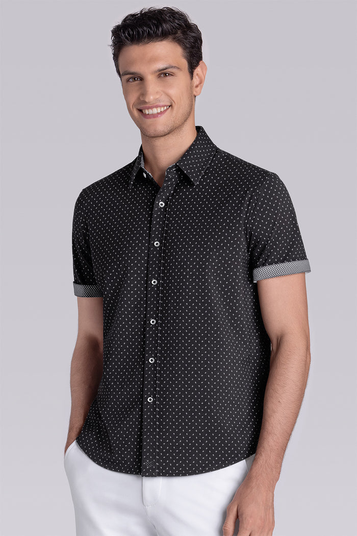 Model wearing Exhilarate Black short sleeve shirt, styled with white shorts