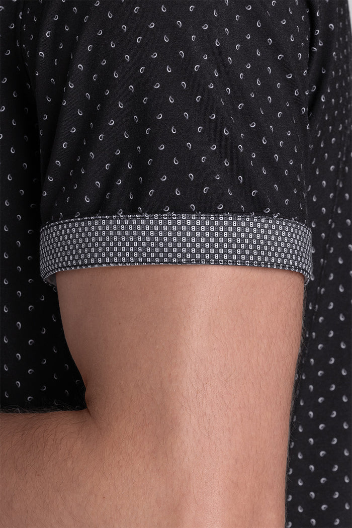 Model wearing Exhilarate Black short sleeve shirt, styled with white shorts
