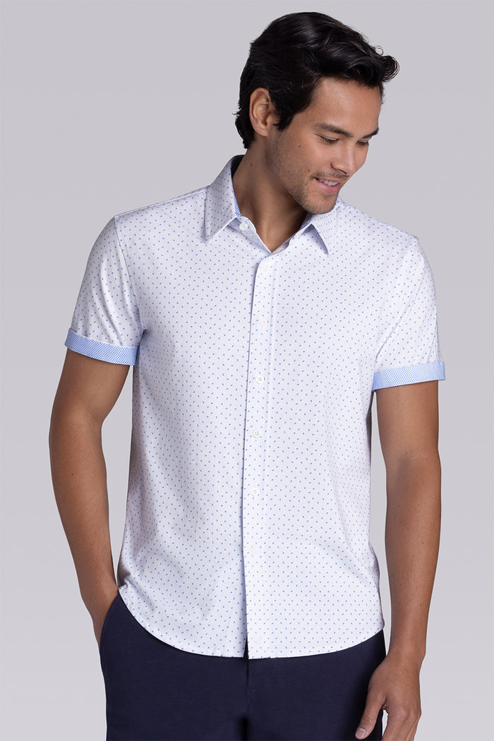 Model wearing Exhilarate White short sleeve shirt, styled with black shorts