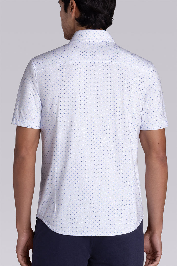 Model wearing Exhilarate White short sleeve shirt, styled with black shorts