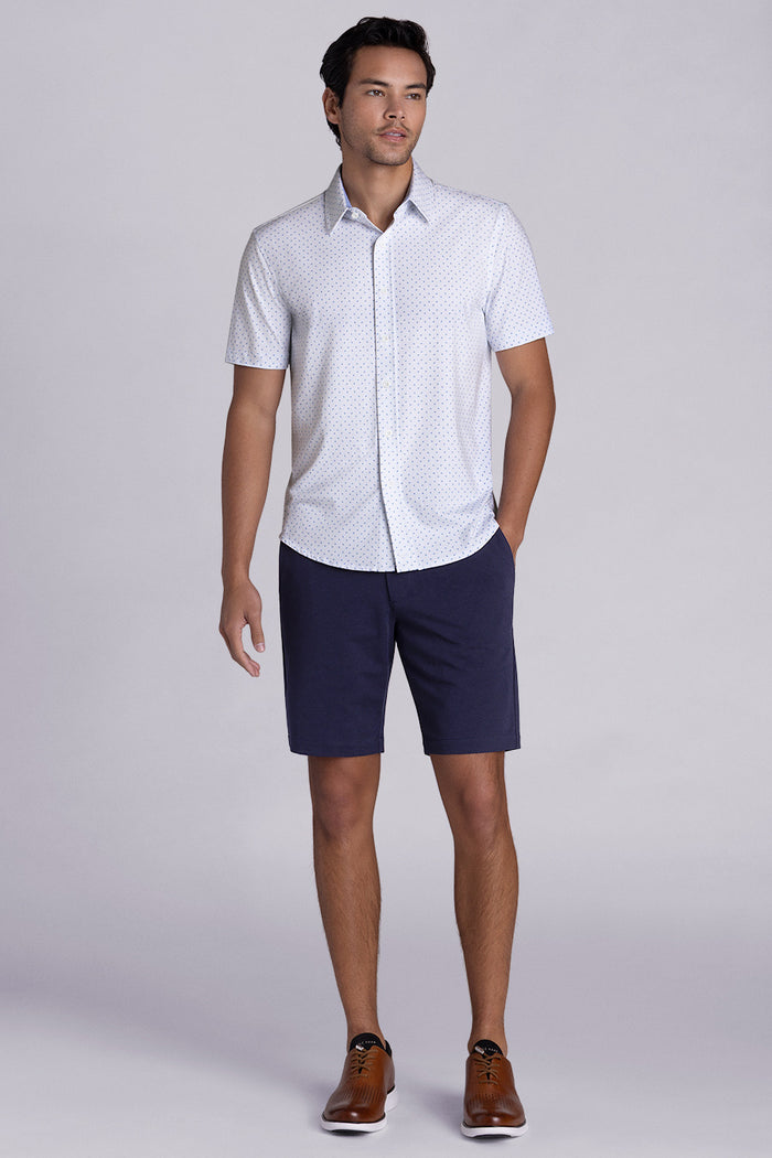 Model wearing Exhilarate White short sleeve shirt, styled with black shorts
