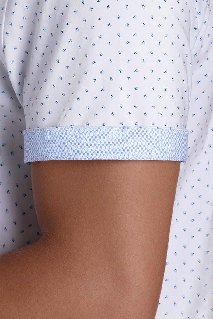 Model wearing Exhilarate White short sleeve shirt, styled with black shorts