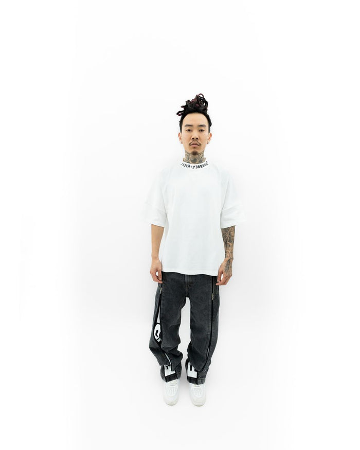 Side profile of the Faith+Figures Faith+ Jumbo SS Tee emphasizing its clean stitching and casual everyday wear appeal