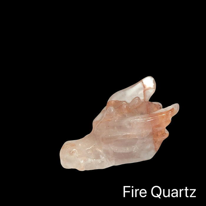Fire Quartz Dragon Head gemstone on a black background, left angle front view.