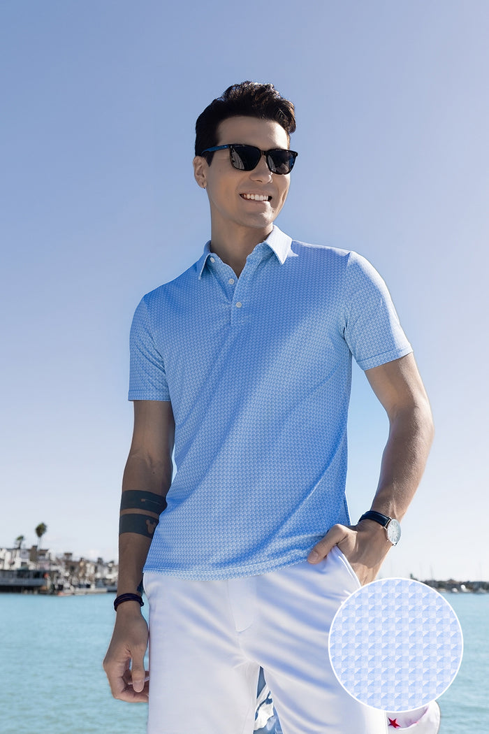 Model wearing Flourish Ocean Blue short sleeve geo print polo, styled with black shorts.