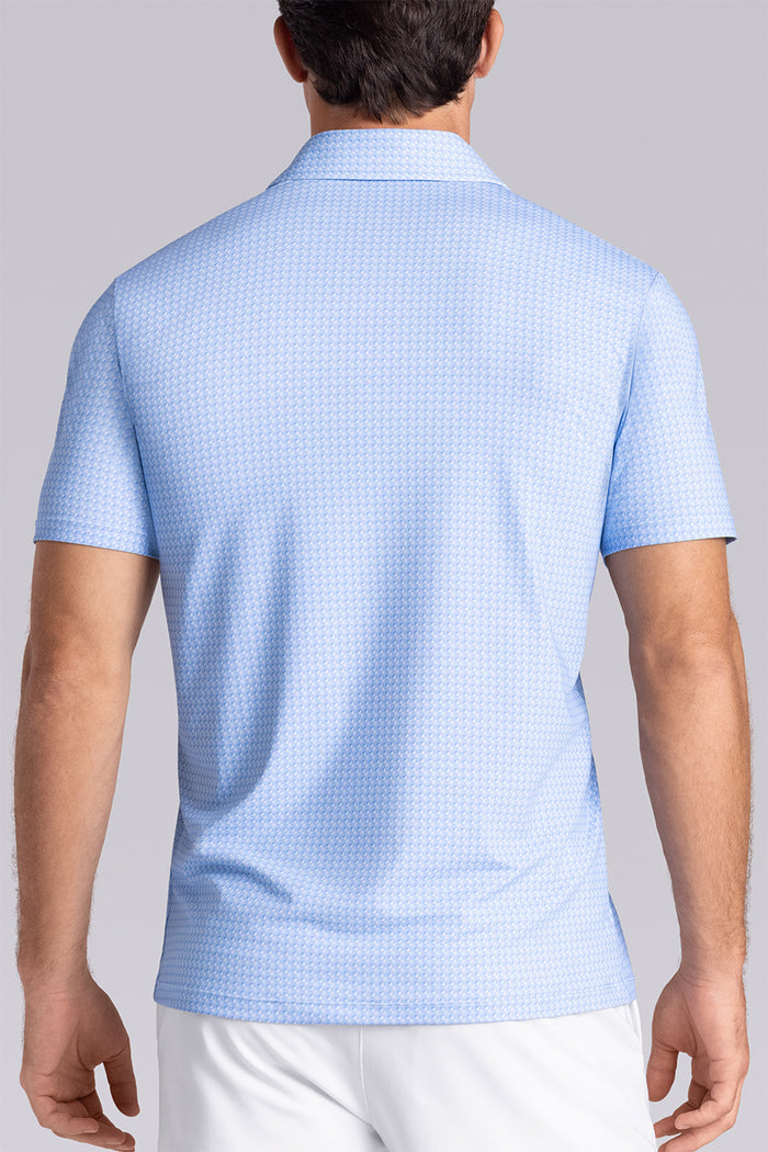 Model wearing Flourish Ocean Blue short sleeve geo print polo, styled with black shorts.