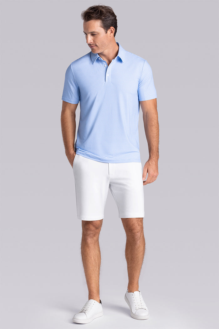Model wearing Flourish Ocean Blue short sleeve geo print polo, styled with black shorts.