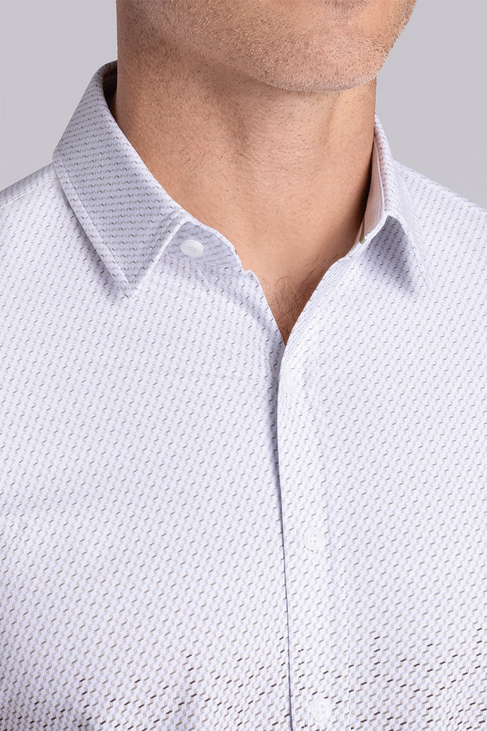 Model wearing Flow Light Sage Cotton® short sleeve ombre print shirt, styled with white shorts