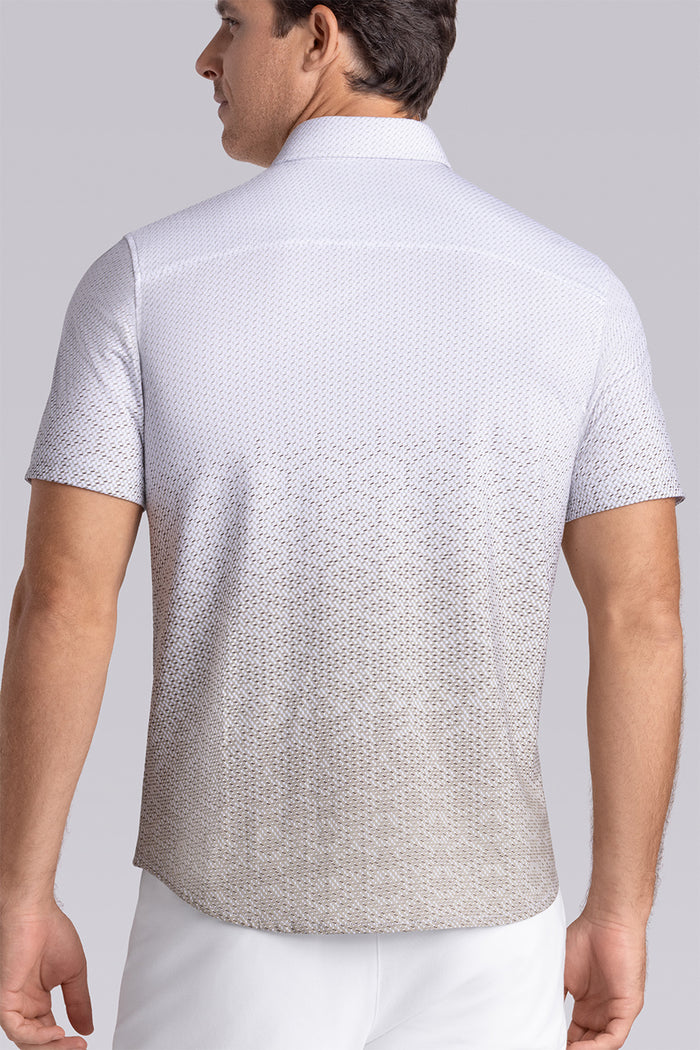 Model wearing Flow Light Sage Cotton® short sleeve ombre print shirt, styled with white shorts