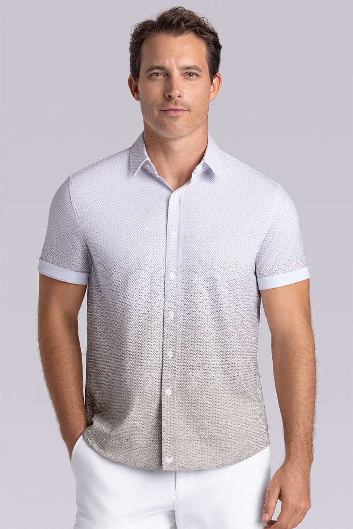 Model wearing Flow Light Sage Cotton® short sleeve ombre print shirt, styled with white shorts