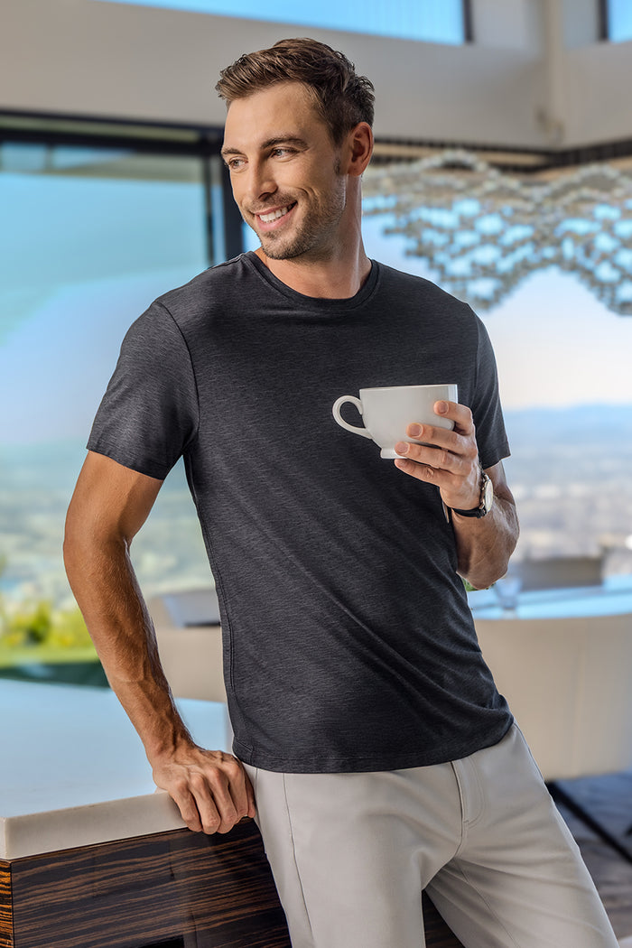 Model wearing Fundamental Black Charcoal Icy Bamboo® short sleeve crewneck, styled with white pants.