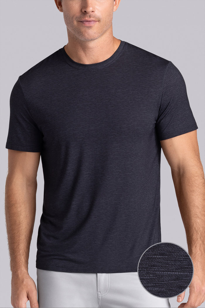 Model wearing Fundamental Black Charcoal Icy Bamboo® short sleeve crewneck, styled with white pants.