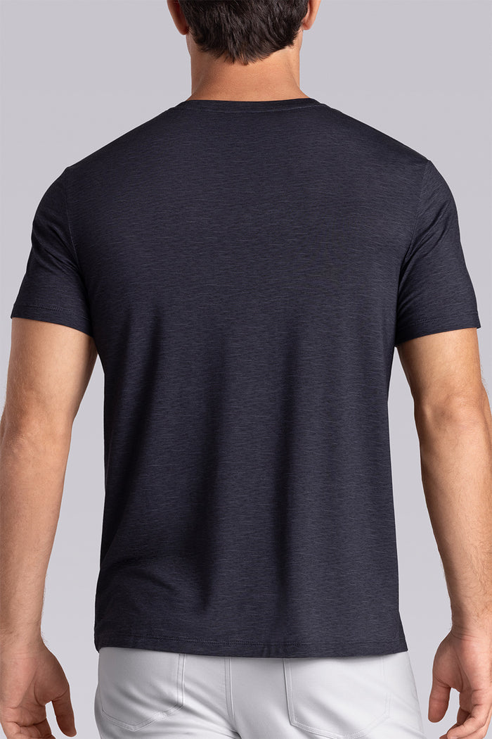 Model wearing Fundamental Black Charcoal Icy Bamboo® short sleeve crewneck, styled with white pants.