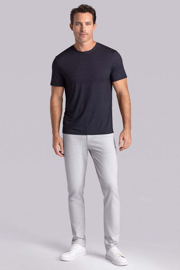 Model wearing Fundamental Black Charcoal Icy Bamboo® short sleeve crewneck, styled with white pants.