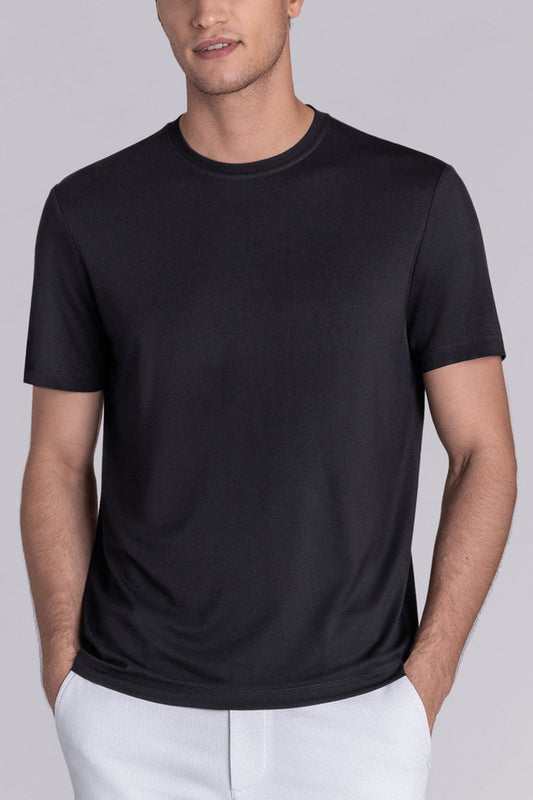 Model wearing Fundamental Black Icy Bamboo® short sleeve crewneck, styled with white shorts.
