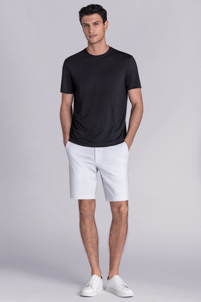 Model wearing Fundamental Black Icy Bamboo® short sleeve crewneck, styled with white shorts.