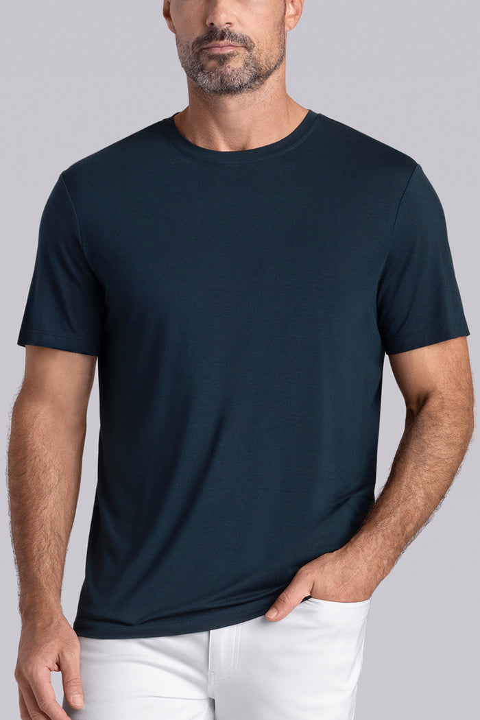 Model wearing Fundamental Black Charcoal Icy Bamboo® short sleeve crewneck, styled with white pants.