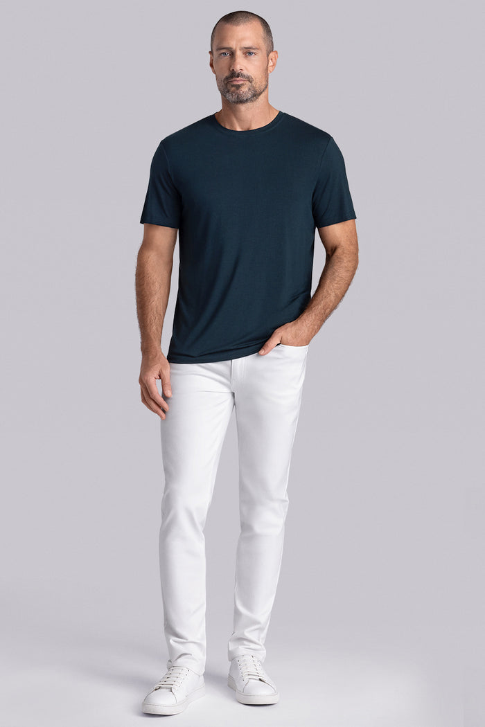 Model wearing Fundamental Black Charcoal Icy Bamboo® short sleeve crewneck, styled with white pants.