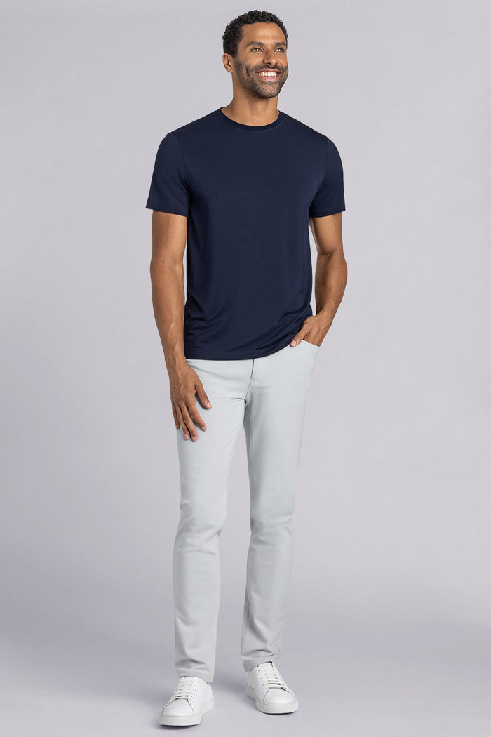 Model wearing Fundamental Monaco Blue Icy Bamboo® short sleeve crewneck, styled with white pants.