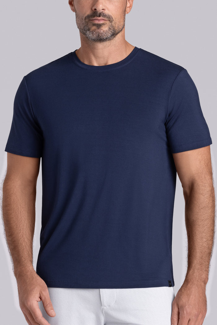 Model wearing Fundamental Legion Blue Icy Bamboo® short sleeve crewneck, styled with white shorts.