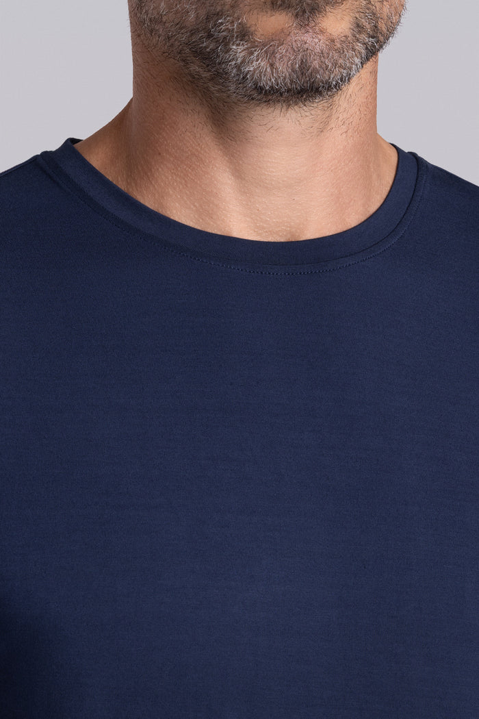 Model wearing Fundamental Legion Blue Icy Bamboo® short sleeve crewneck, styled with white shorts.