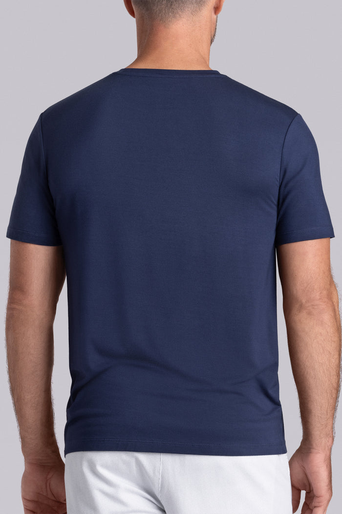 Model wearing Fundamental Legion Blue Icy Bamboo® short sleeve crewneck, styled with white shorts.