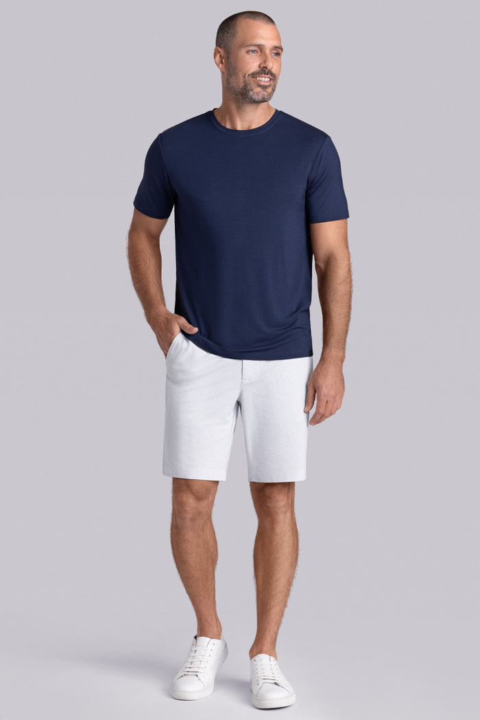 Model wearing Fundamental Legion Blue Icy Bamboo® short sleeve crewneck, styled with white shorts.