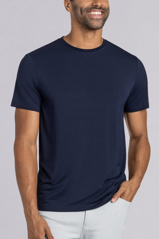 Model wearing Fundamental Monaco Blue Icy Bamboo® short sleeve crewneck, styled with white pants.