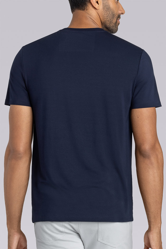 Model wearing Fundamental Monaco Blue Icy Bamboo® short sleeve crewneck, styled with white pants.