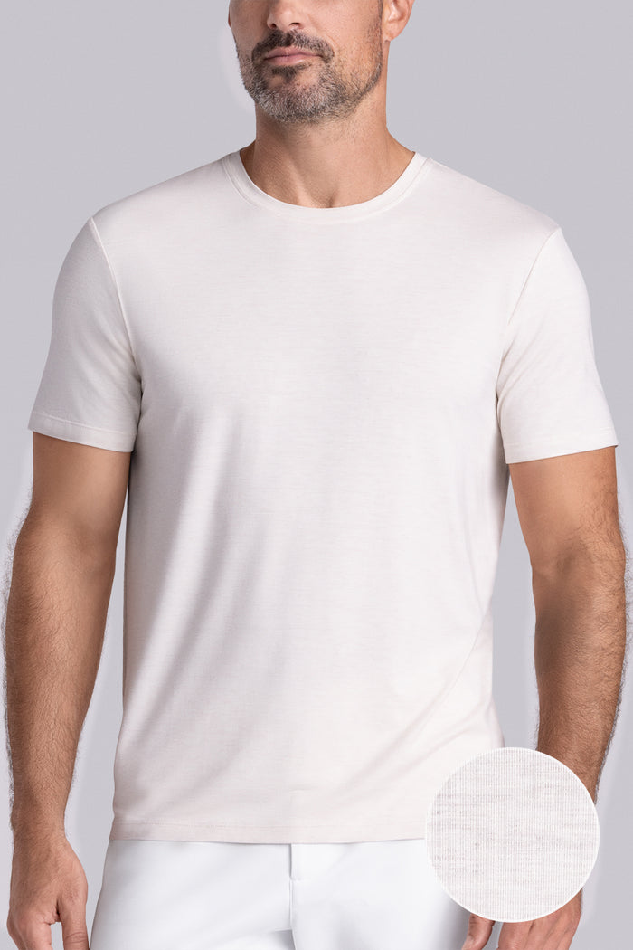 Model wearing the Fundamental Natural White Heather Icy Bamboo® short sleeve crewneck, styled with white shorts.