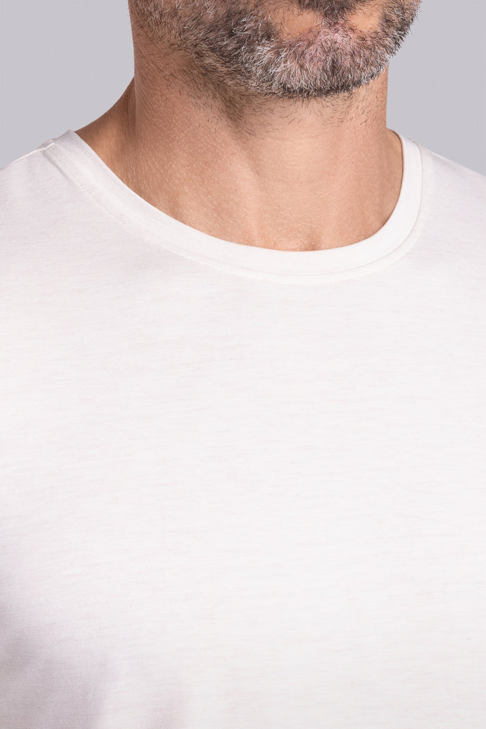 Model wearing the Fundamental Natural White Heather Icy Bamboo® short sleeve crewneck, styled with white shorts.