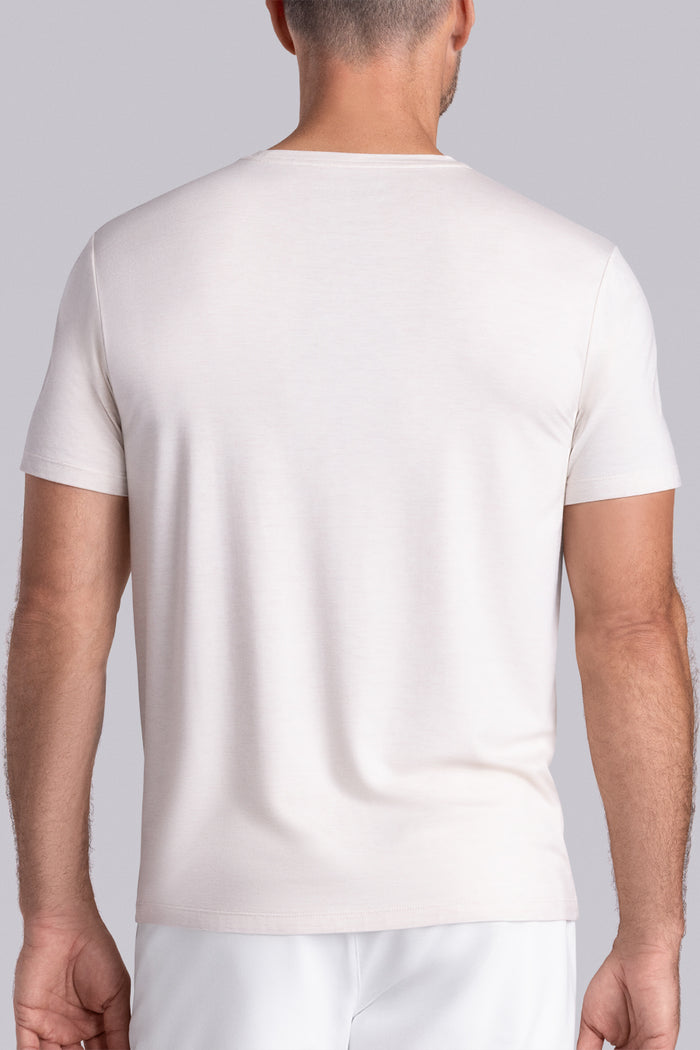Model wearing the Fundamental Natural White Heather Icy Bamboo® short sleeve crewneck, styled with white shorts.