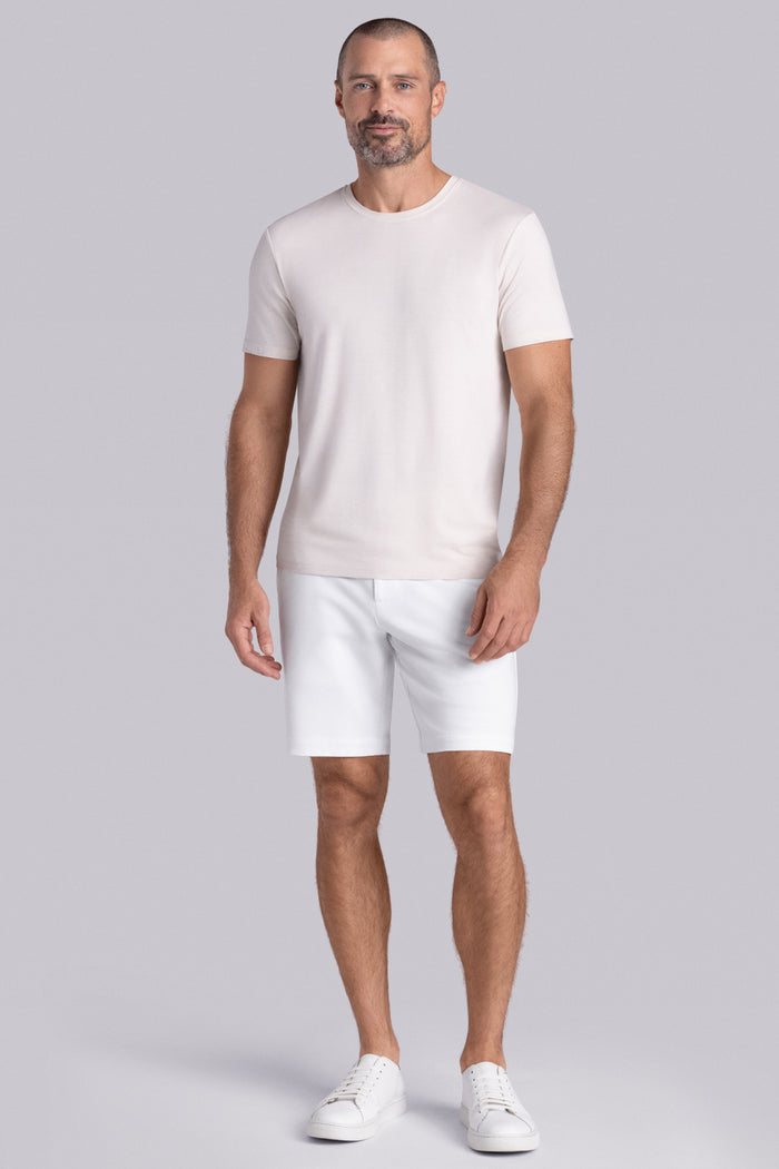 Model wearing the Fundamental Natural White Heather Icy Bamboo® short sleeve crewneck, styled with white shorts.