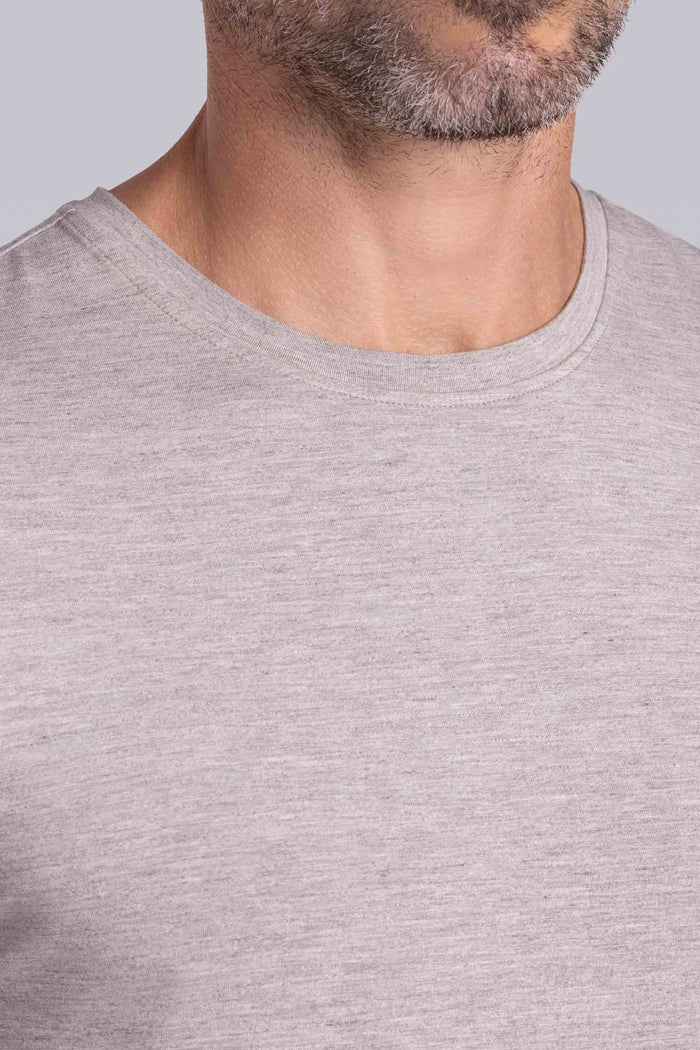 Model wearing the Fundamental Oak Tree Heather Icy Bamboo® short sleeve crewneck, styled with white shorts.