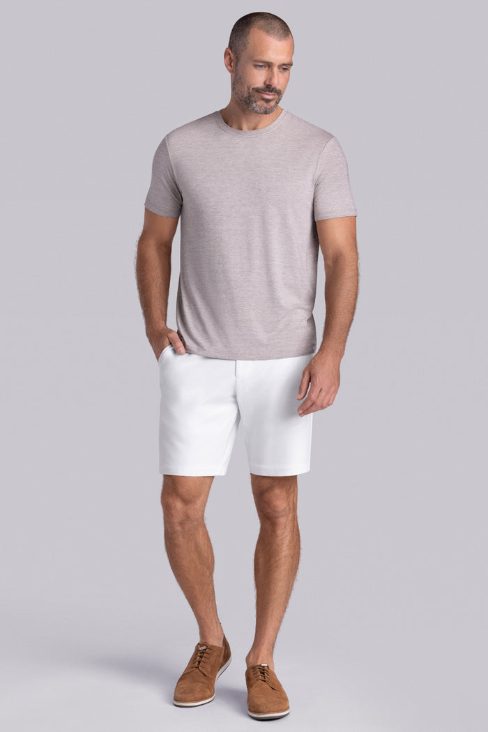 Model wearing the Fundamental Oak Tree Heather Icy Bamboo® short sleeve crewneck, styled with white shorts.