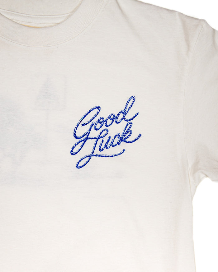 Off white t-shirt with Good Luck rope design in blue