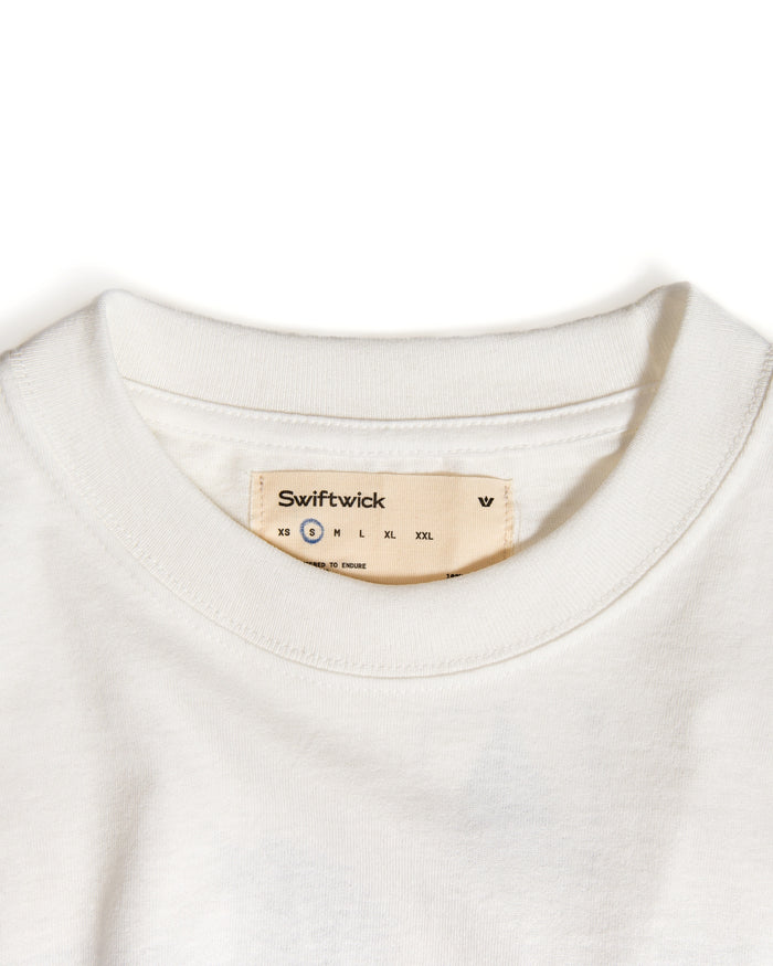 Close-up of an off white shirt with a size label