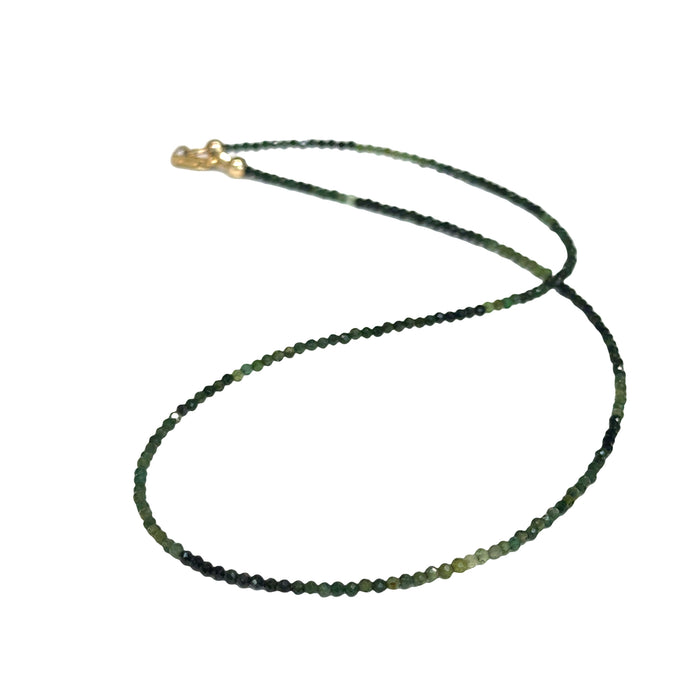Faceted green tourmaline gemstone necklace with gold-filled lobster claw clasp on white background, front long overview.