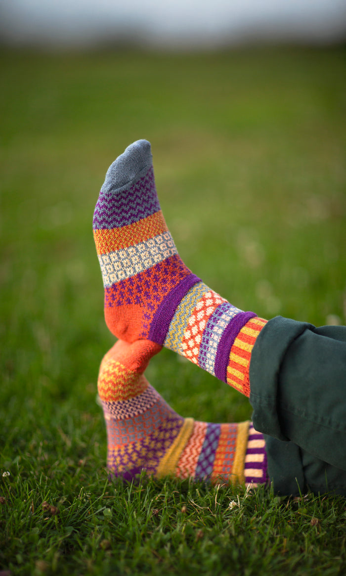 Solmate Hazel crew socks with colourful mismatched pattern outdoors