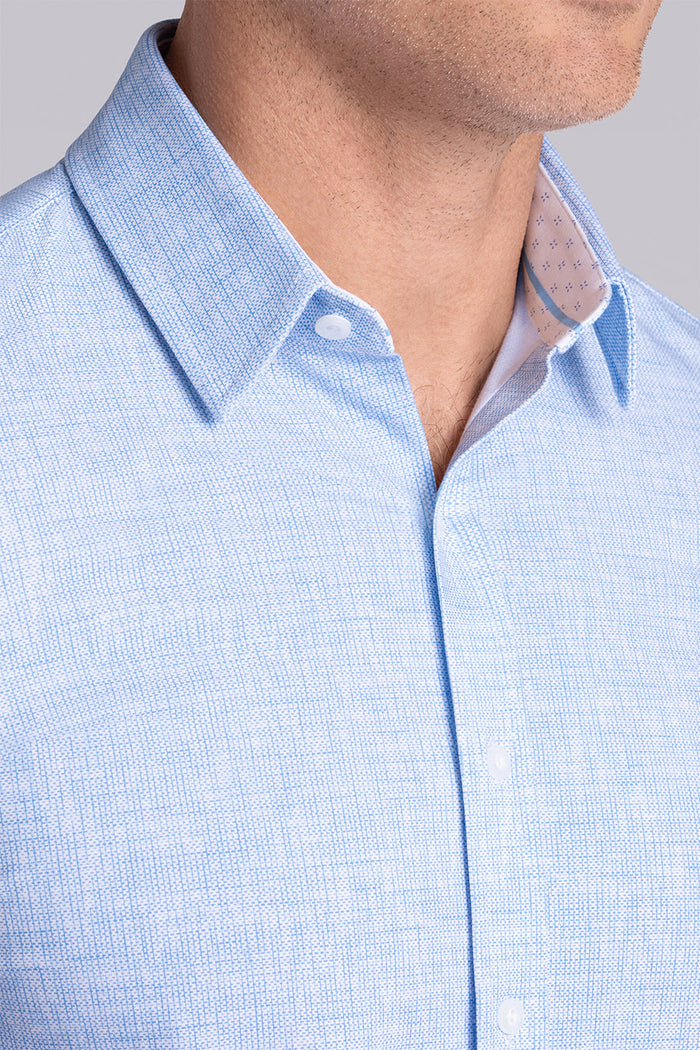 Model wearing Horizon Haze Blue Icy Cotton® short sleeve shirt classic collar, styled with white shorts